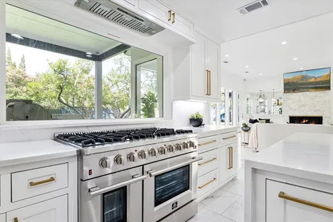 a white stove top oven sitting inside of a kitchen