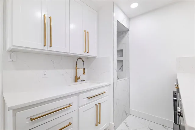 a kitchen with a sink and cabinets