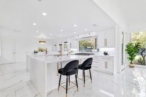 a kitchen with a sink stainless steel appliances and cabinets