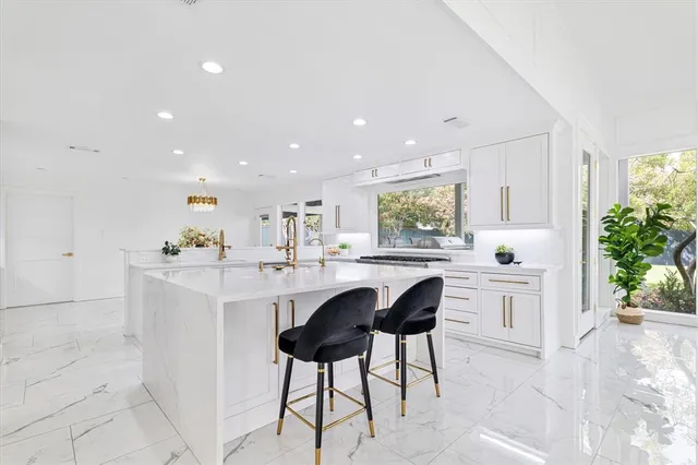 a kitchen with a sink stainless steel appliances and cabinets
