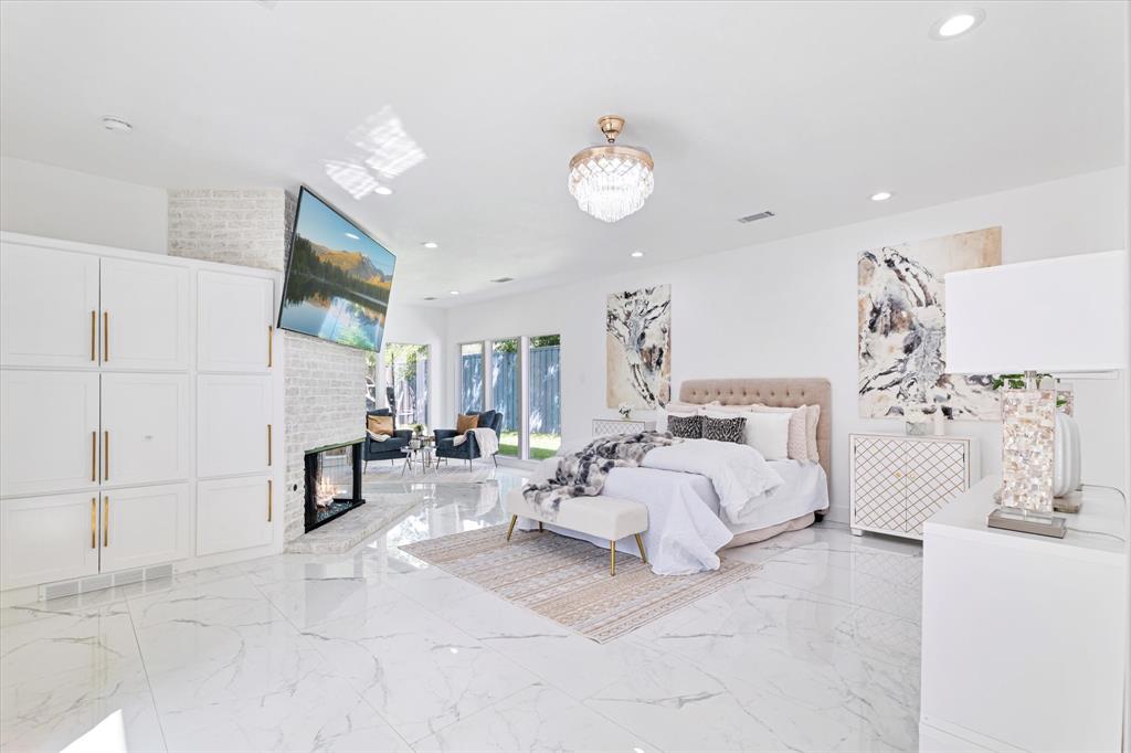 5407 Westgrove Drive Dallas, TX 75248 - Photo 19 of 40 a spacious bedroom with a bed and a couch