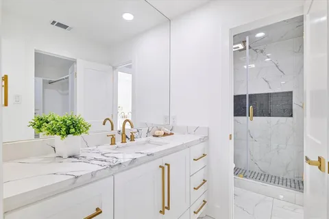 a bathroom with a double vanity sink and a mirror