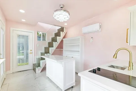 a bathroom with a granite countertop sink a toilet a shower and a mirror