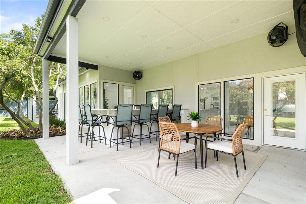5407 Westgrove Drive Dallas, TX 75248 - Photo 37 of 40 a view of a patio with table and chairs and floor to ceiling window