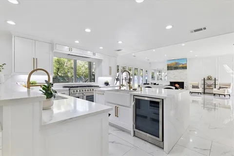a kitchen with counter top space and living room
