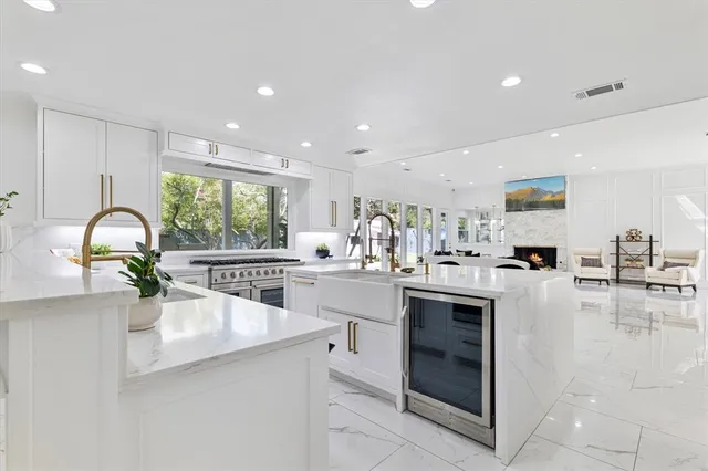 a kitchen with counter top space and living room