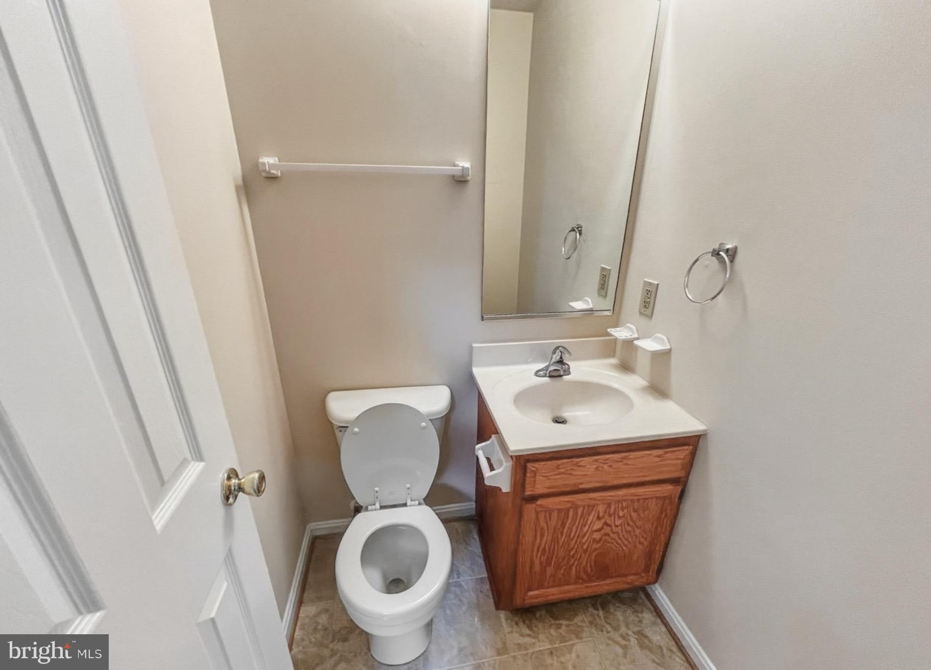 3607 Harbor Road Chesapeake Beach, MD 20732 - Photo 21 of 27 a bathroom with a toilet sink and mirror
