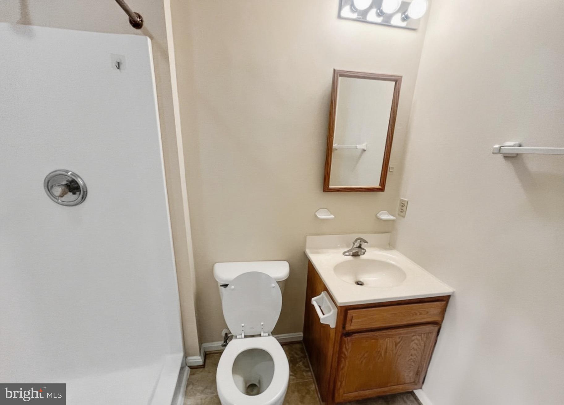 3607 Harbor Road Chesapeake Beach, MD 20732 - Photo 10 of 27 a bathroom with a toilet sink and mirror