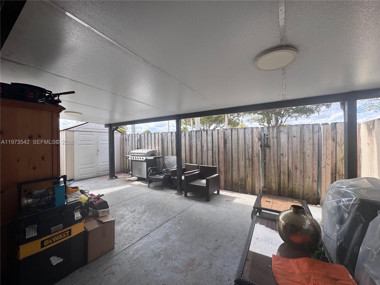 5252 Southwest 139th Place, Unit 5252 Miami, FL 33175 - Photo 13 of 15 a living room with furniture and a large window