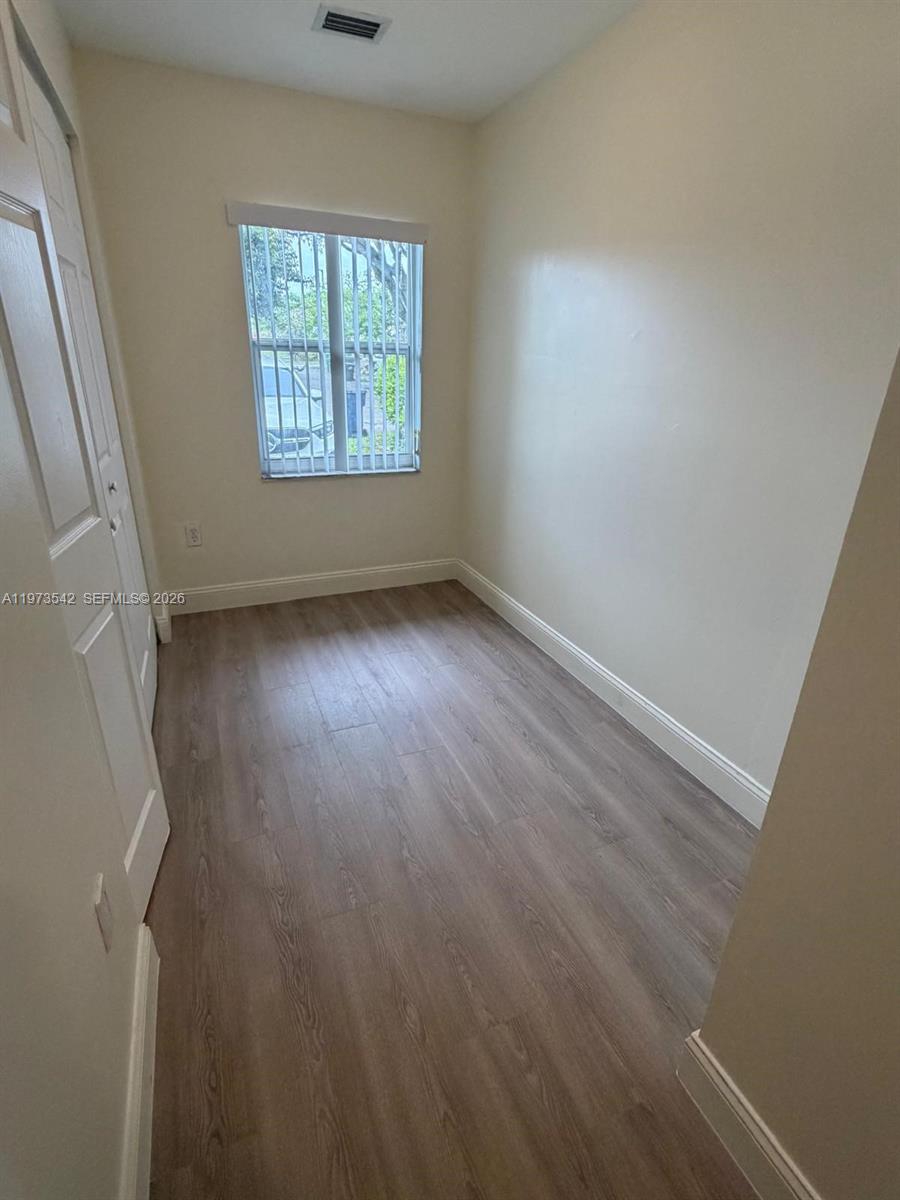 5252 Southwest 139th Place, Unit 5252 Miami, FL 33175 - Photo 17 of 18 an empty room with windows