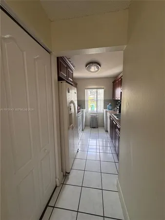 a hallway with a washer and dryer