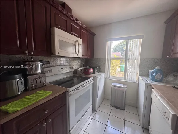 a kitchen with a stove a sink and a microwave