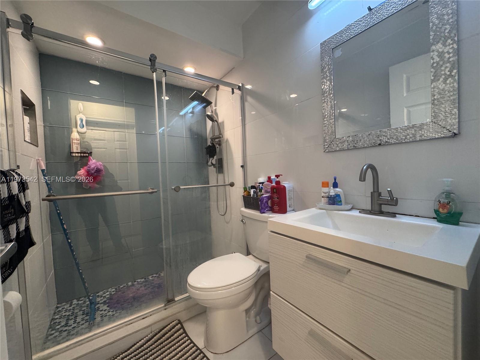 5252 Southwest 139th Place, Unit 5252 Miami, FL 33175 - Photo 7 of 18 a bathroom with a sink toilet and shower