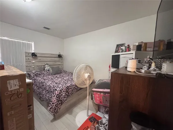 a bed room with a bed and a television