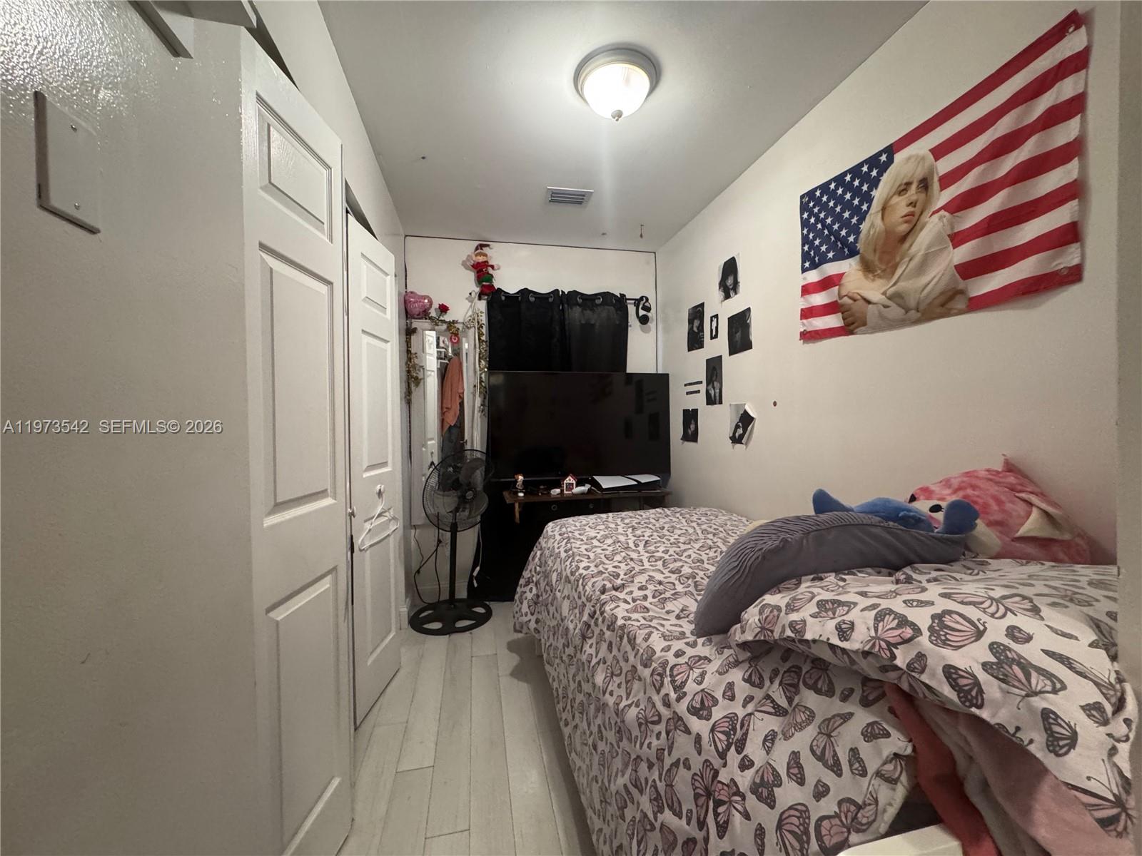 5252 Southwest 139th Place, Unit 5252 Miami, FL 33175 - Photo 9 of 15 a bedroom with a bed and a television