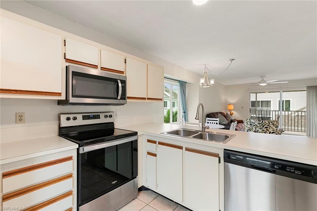 2189 San Marco Road, Unit 3201 Marco Island, FL 34145 - Photo 11 of 27 a kitchen with a sink stainless steel appliances and cabinets