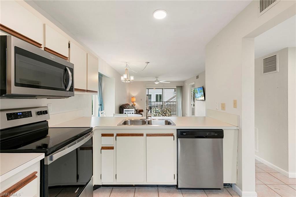 2189 San Marco Road, Unit 3201 Marco Island, FL 34145 - Photo 12 of 27 a kitchen with a sink stove and microwave
