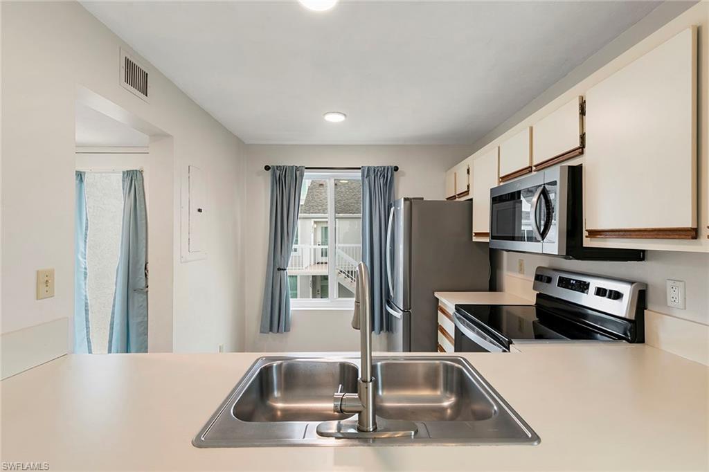 2189 San Marco Road, Unit 3201 Marco Island, FL 34145 - Photo 14 of 27 a kitchen with stainless steel appliances a refrigerator a stove a microwave a sink and a refrigerator