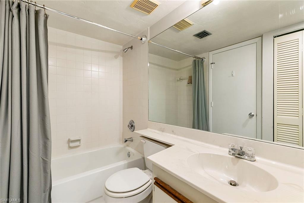 2189 San Marco Road, Unit 3201 Marco Island, FL 34145 - Photo 19 of 27 a bathroom with a bathtub shower sink vanity mirror and toilet