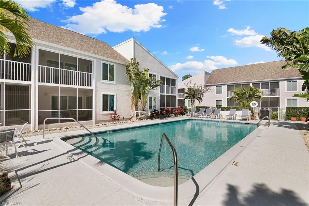 2189 San Marco Road, Unit 3201 Marco Island, FL 34145 - Photo 23 of 27 a view of a patio with swimming pool table and chairs