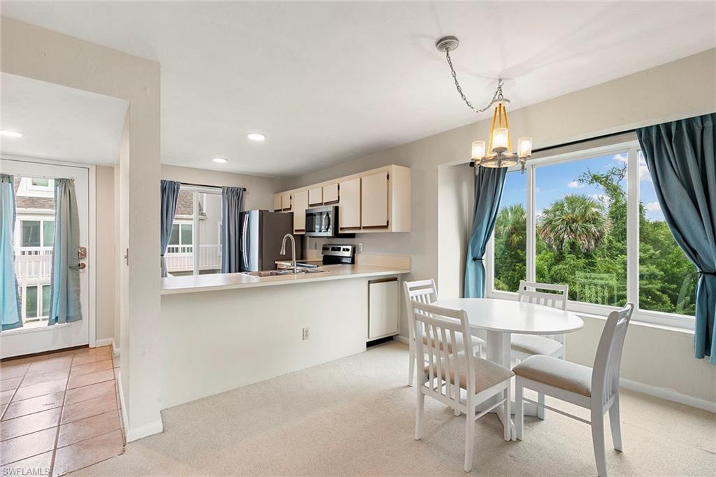 2189 San Marco Road, Unit 3201 Marco Island, FL 34145 - Photo 10 of 27 a open dining room with stainless steel appliances kitchen island a table and chairs in it