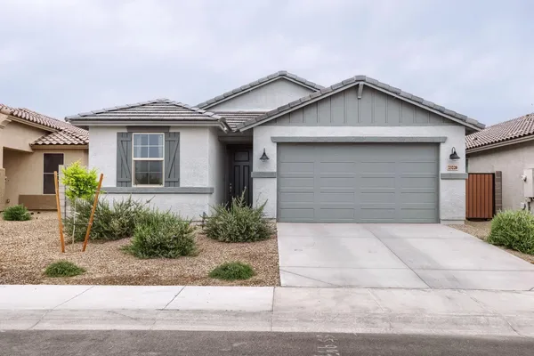 a front view of a house with a yard and garage