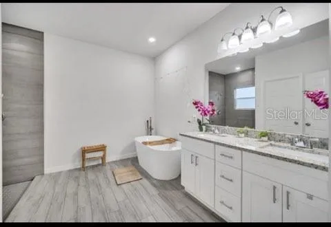 a spacious bathroom with a double vanity sink mirror and