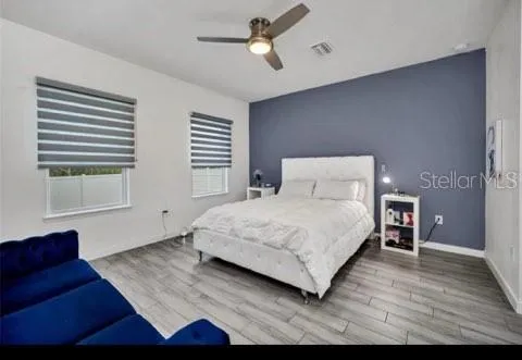 a bedroom with a large bed and a chandelier