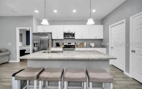 a kitchen with cabinets and stainless steel appliances