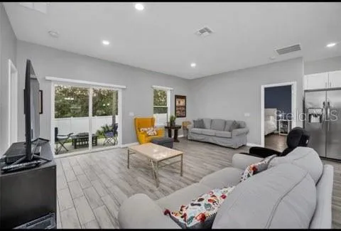 a living room with furniture and a large window