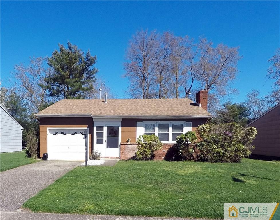125 Georgetown Road Toms River, NJ 08757 - Photo 1 of 25 a front view of a house with a garden and trees