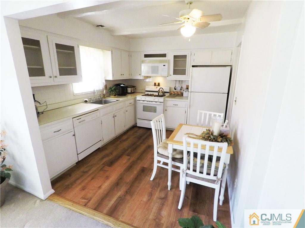 125 Georgetown Road Toms River, NJ 08757 - Photo 16 of 25 a kitchen with white cabinets and stainless steel appliances