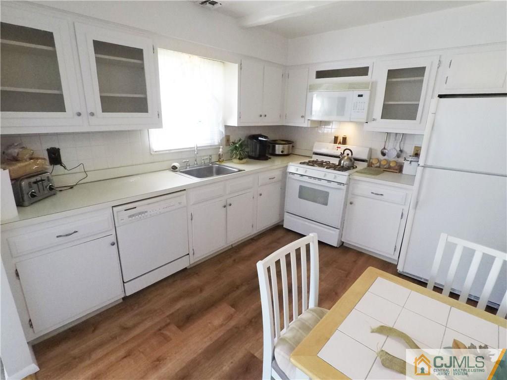 125 Georgetown Road Toms River, NJ 08757 - Photo 17 of 25 a kitchen with white cabinets sink and white appliances