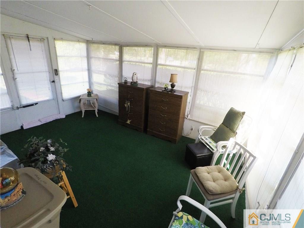 125 Georgetown Road Toms River, NJ 08757 - Photo 23 of 25 a living room with furniture floor to ceiling window and chair