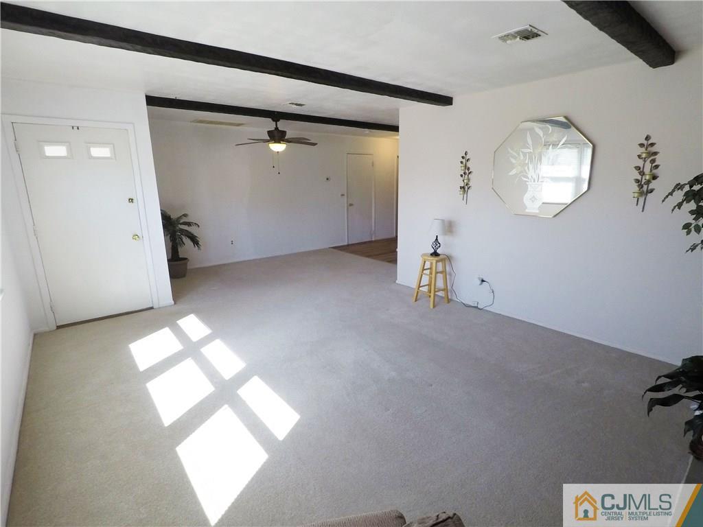125 Georgetown Road Toms River, NJ 08757 - Photo 7 of 25 en empty room with windows and chandelier