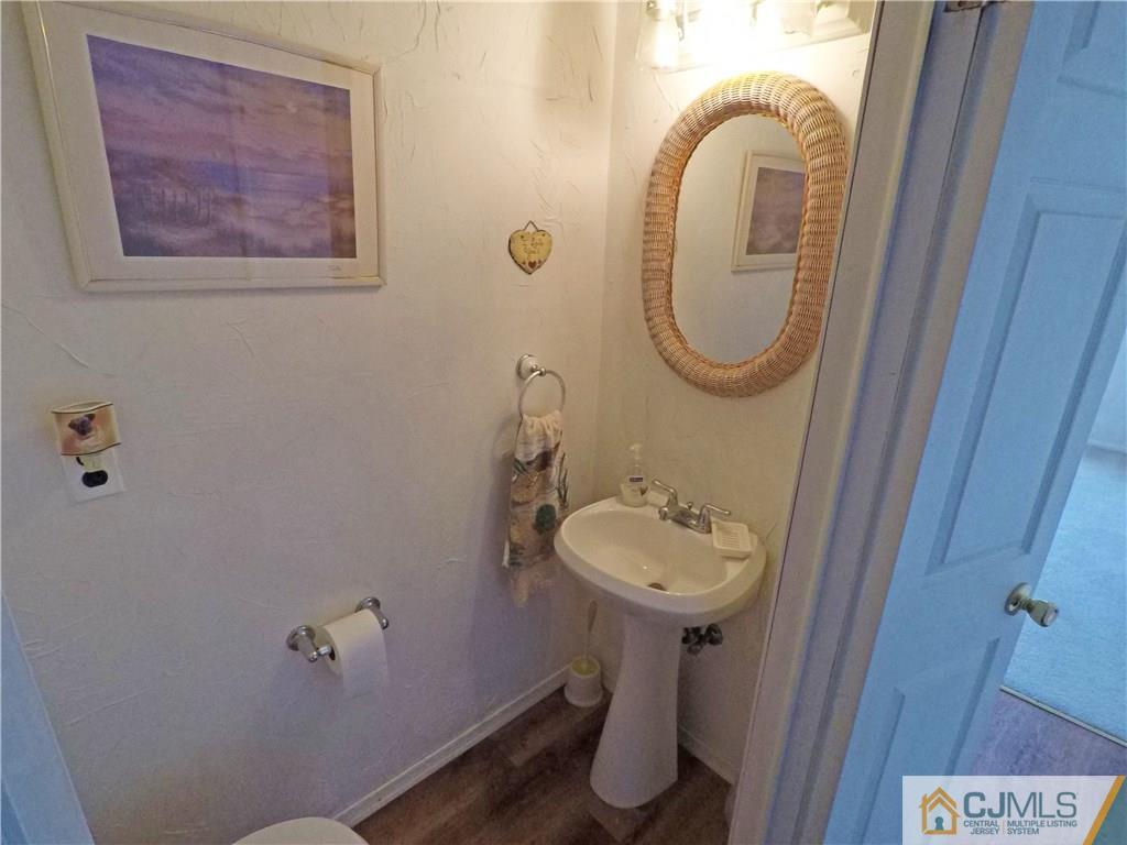 125 Georgetown Road Toms River, NJ 08757 - Photo 9 of 25 a bathroom with a sink mirror and toilet