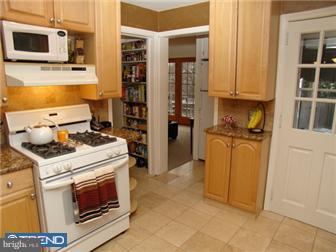 246 Harrogate Road Wynnewood, PA 19096 - Photo 3 of 12 a kitchen with a stove and a refrigerator