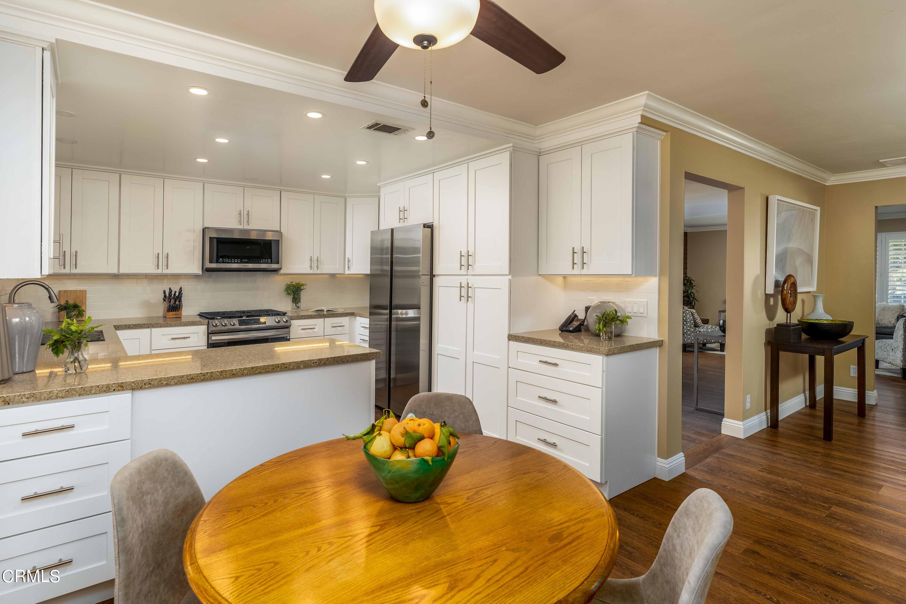 1038 Leandra Lane Arcadia, CA 91006 - Photo 14 of 36 a kitchen with stainless steel appliances granite countertop a refrigerator a stove a sink dishwasher and white cabinets with wooden floor