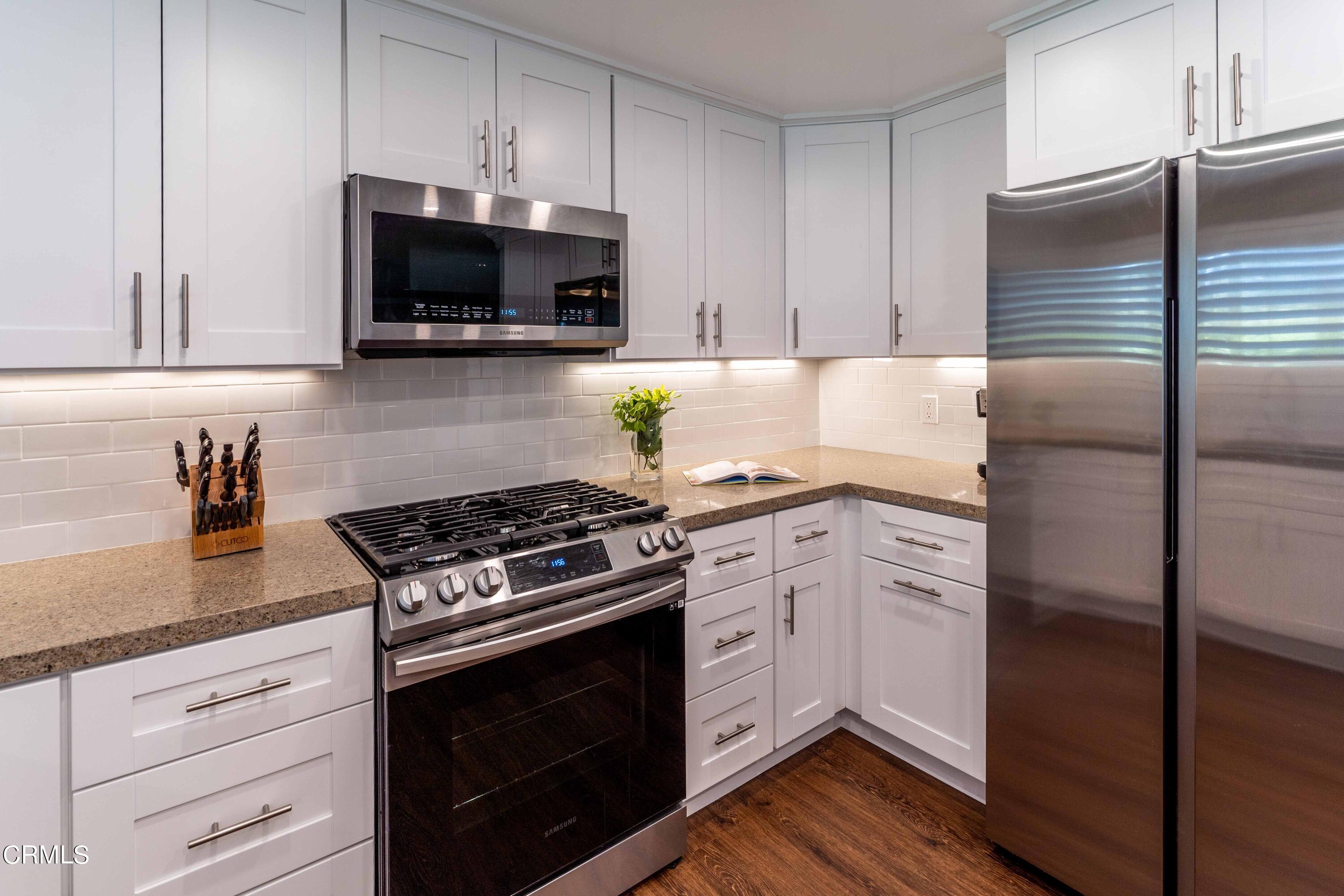 1038 Leandra Lane Arcadia, CA 91006 - Photo 16 of 36 a kitchen with granite countertop a stove and a microwave