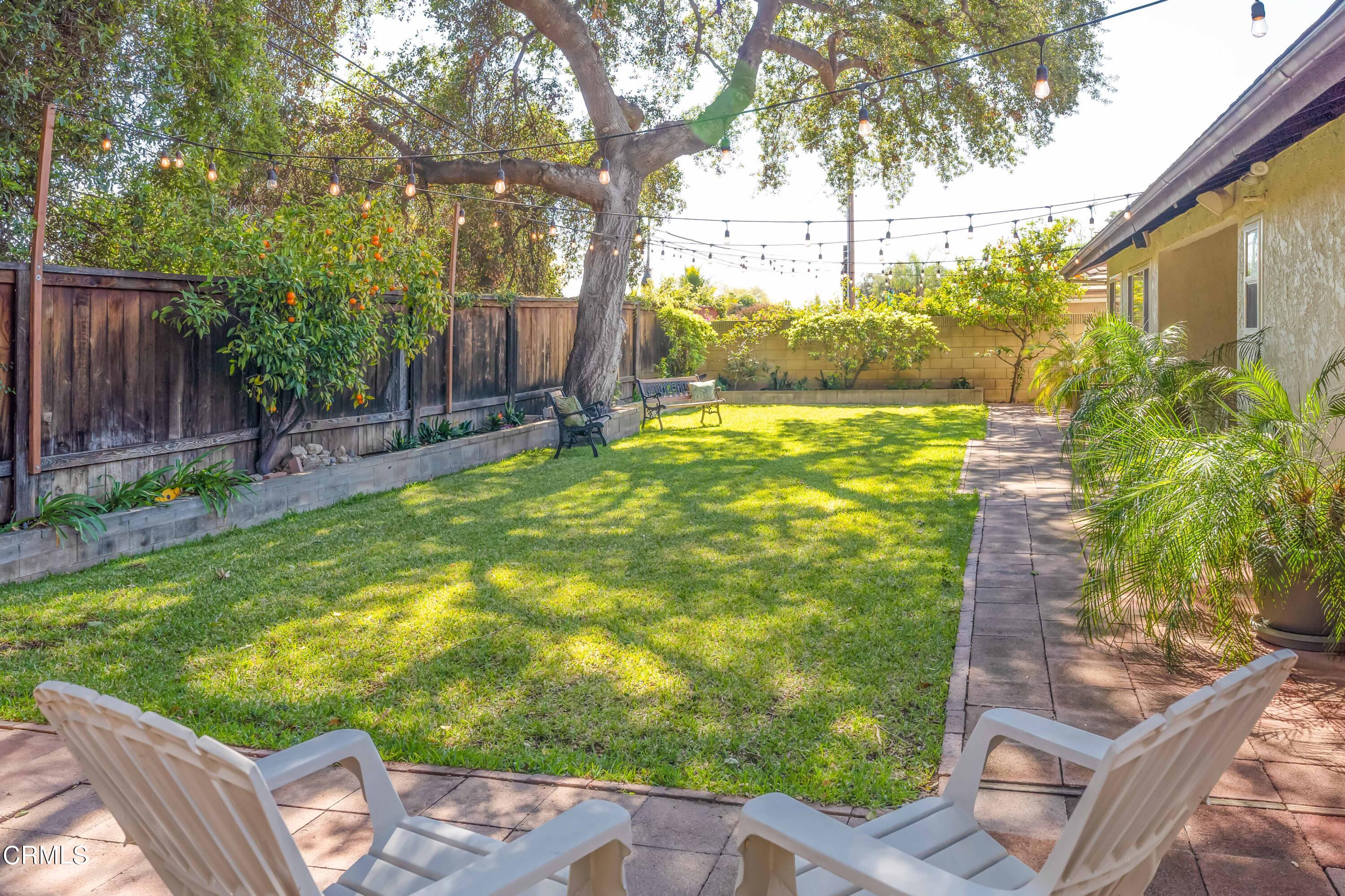 1038 Leandra Lane Arcadia, CA 91006 - Photo 32 of 36 a backyard of a house with table and chairs plants and large tree