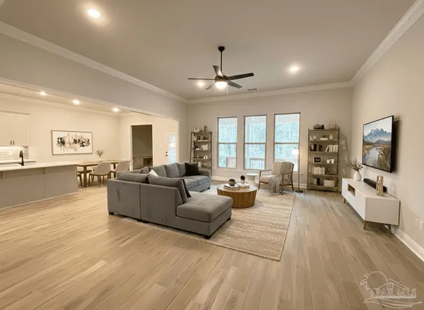 a living room with furniture and a flat screen tv