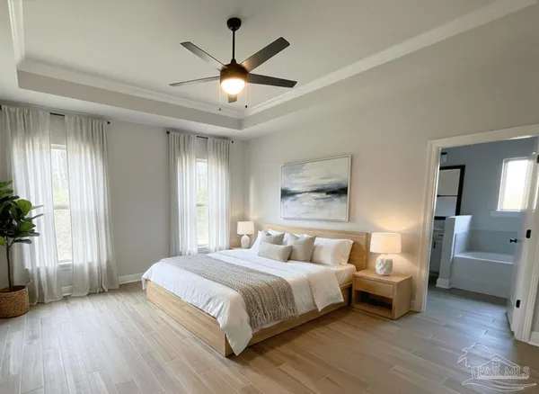 a bedroom with a large bed a chandelier and a window