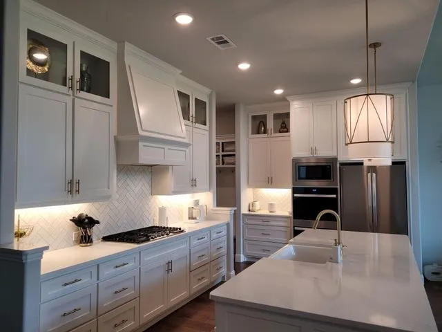 a kitchen with stainless steel appliances granite countertop a sink a stove and a refrigerator