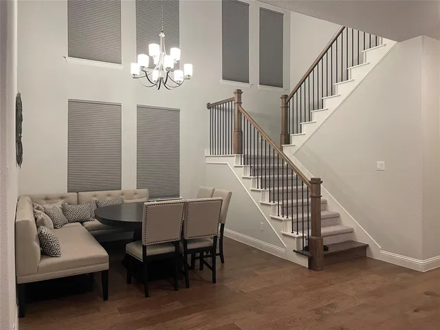 a view of a dining room with furniture and a chandelier
