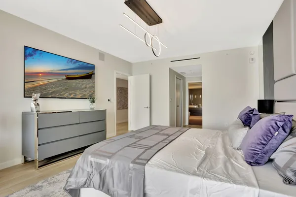 a bedroom with a bed and a flat screen tv