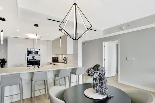 a dining room with furniture and a chandelier