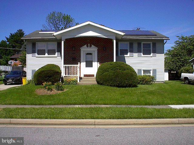 6002 Chesworth Road Baltimore, MD 21228 - Photo 1 of 26 a front view of a house with a garden