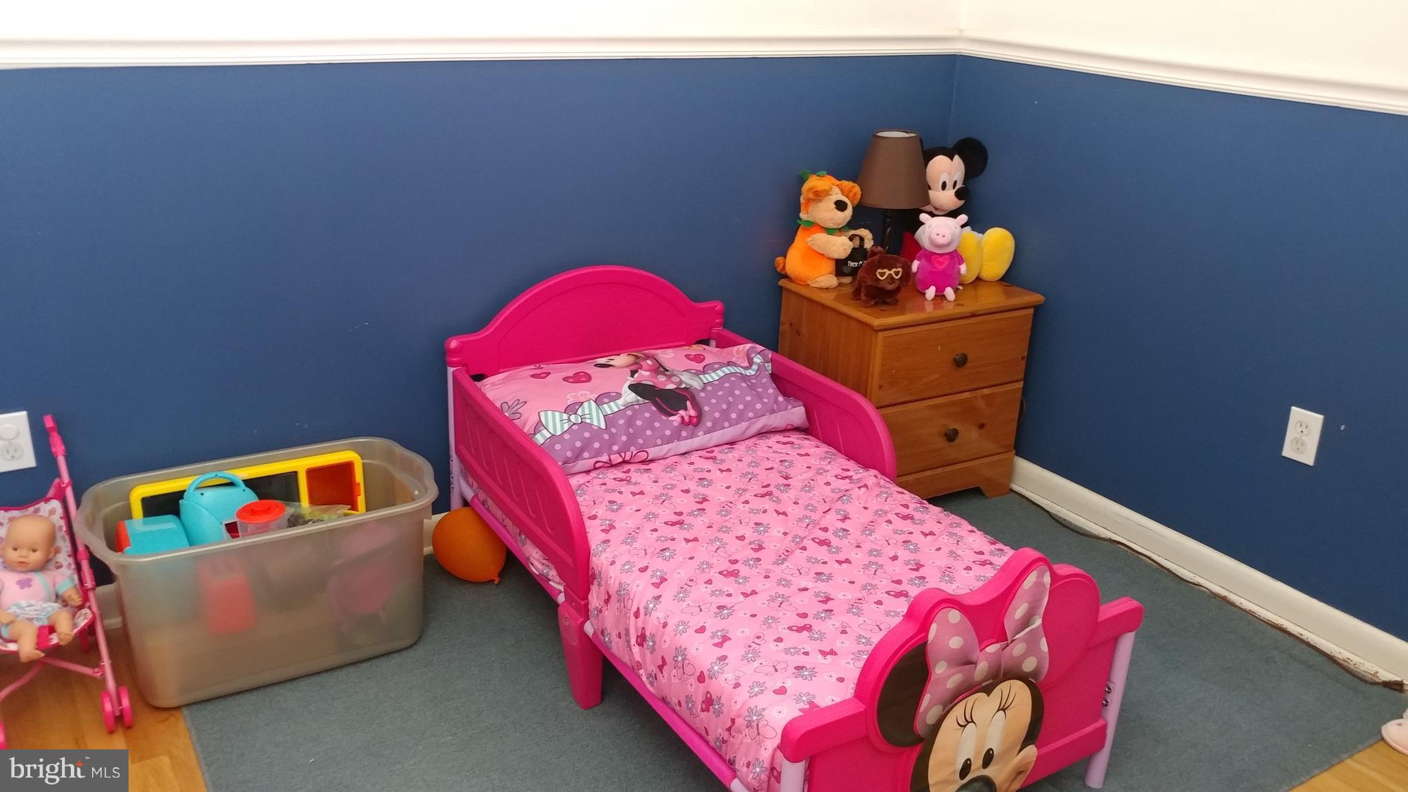 6002 Chesworth Road Baltimore, MD 21228 - Photo 12 of 26 a bed room with a bed and a couch