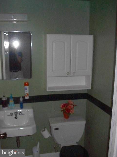 6002 Chesworth Road Baltimore, MD 21228 - Photo 17 of 26 a bathroom with a sink and a mirror