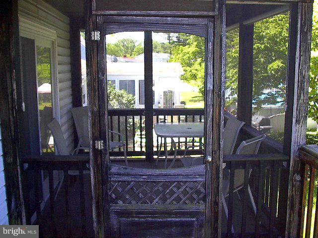 6002 Chesworth Road Baltimore, MD 21228 - Photo 21 of 26 a view of a balcony with wooden floor